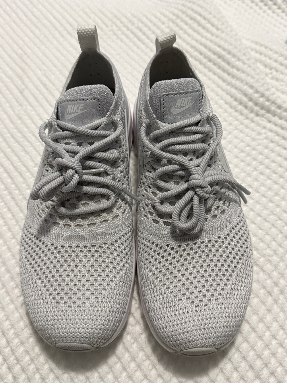 The image shows a pair of light gray Nike Air Max Thea Ultra Flyknit sneakers fe